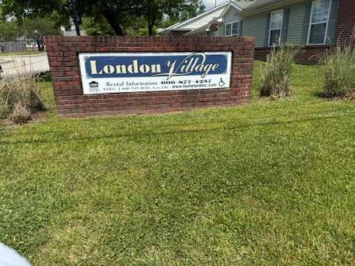 A sign for London Village with rental information on it.