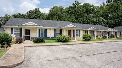A row of houses with a driveway in front.