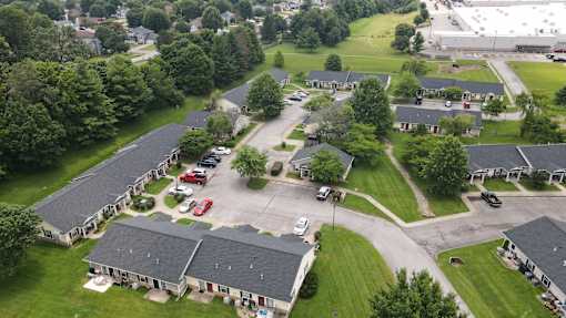 A bird's eye view of a residential area with houses and cars.