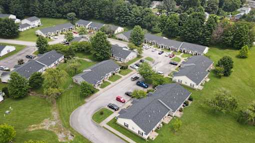 A bird's eye view of a residential area with houses and cars.