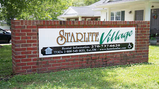 A sign for Starlite Village with rental information and contact details.