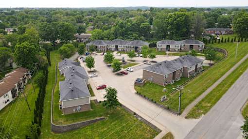 A bird's eye view of a residential area with houses and cars.