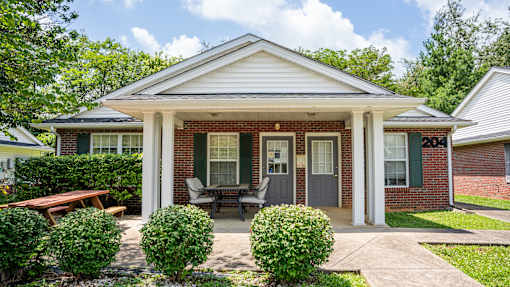 A house with a white porch and a covered patio.