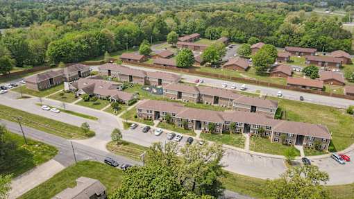 A bird's eye view of a residential area with houses and cars.
