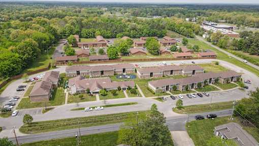 A bird's eye view of a residential area with houses and cars.