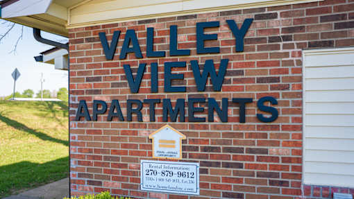 A brick building with a sign that says Valley View Apartments.