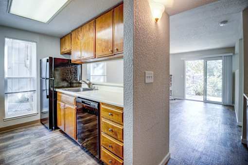 A kitchen with wooden cabinets and a refrigerator.