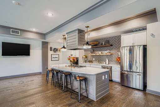 A modern kitchen with a large island and stainless steel appliances.