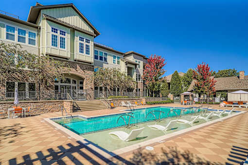A large house with a pool in front.