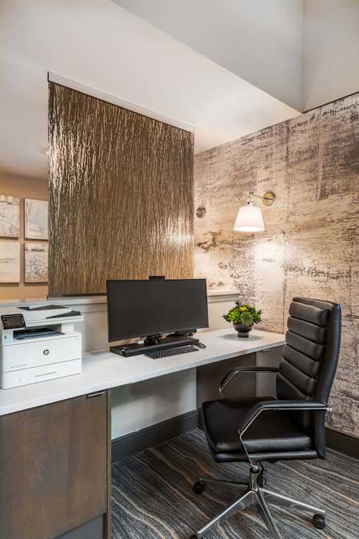 Resident co-working area featuring open workstations, contemporary seating, and professional office amenities.
