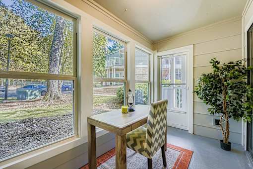 A dining room with a table and chairs.