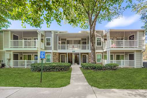 Apartment complex with a blue sign in front.
