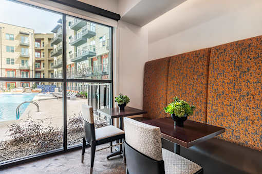 Resident co-working area featuring open workstations, contemporary seating, and professional office amenities.