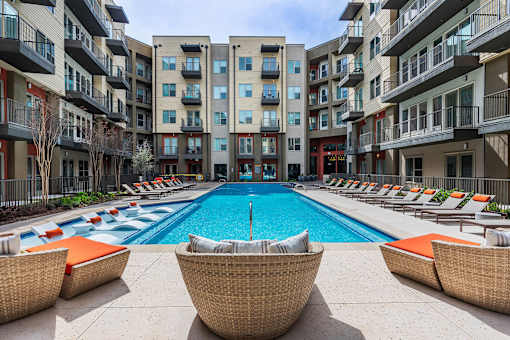 Resort-inspired pool area with clear water and surrounding lounge chairs.