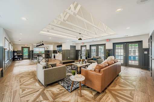 A spacious living room with a large sectional sofa and a coffee table.