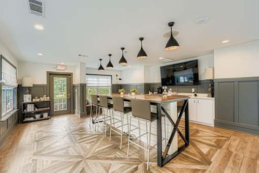 A kitchen with a large island and a dining table.