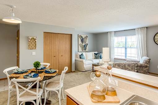 A kitchen with a dining table set for four.