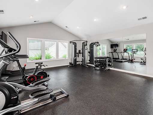 A spacious home gym with a variety of exercise equipment.