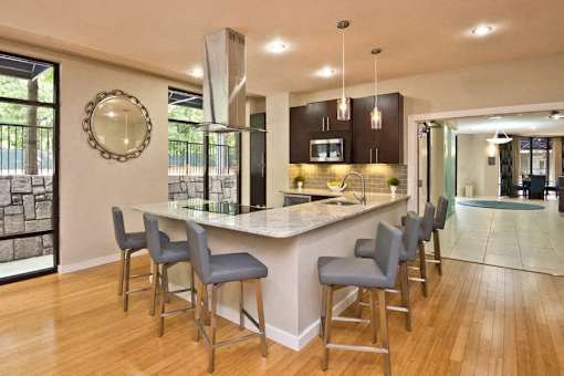 A kitchen with a bar area and chairs.