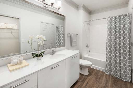A bathroom with a white sink, toilet, and bathtub.