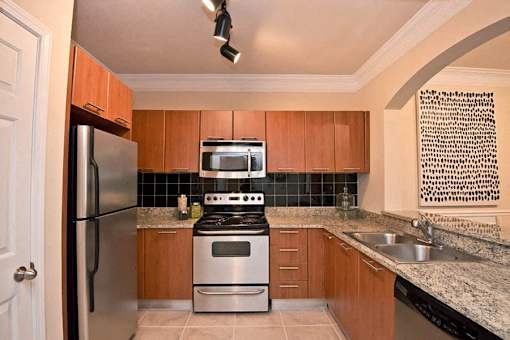 A kitchen with a stove top oven and microwave.
