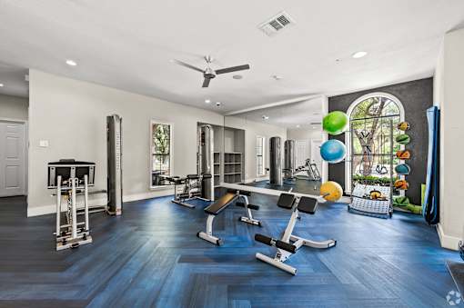 A spacious home gym with a variety of exercise equipment.