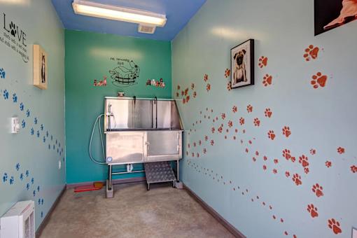 A room with a blue wall and a fridge.