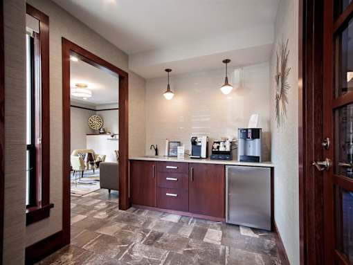 A kitchen with a refrigerator, microwave, and oven.