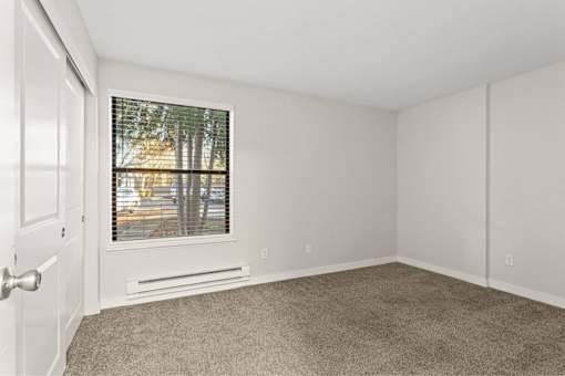 A room with a window and a door.