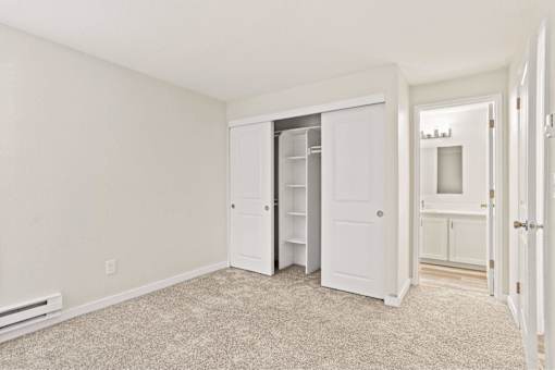 A room with a white door and a white cabinet.
