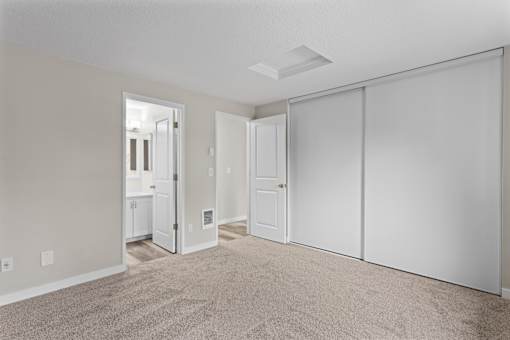 A room with a carpeted floor and white walls.