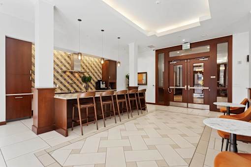 A white and wood themed cafe with a bar area.