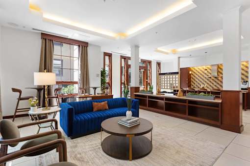 A living room with a blue sofa and a coffee table.
