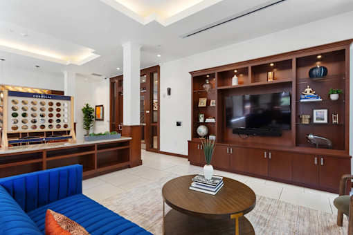 A living room with a blue sofa and a wooden coffee table.