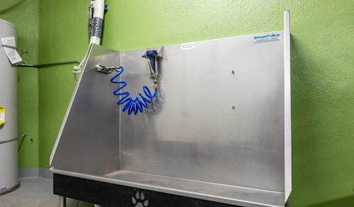 A metal table with a blue spring attached to it.