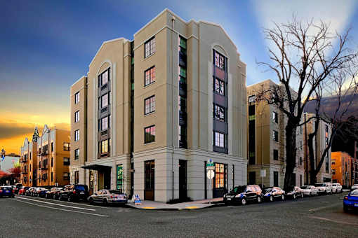 A large building with a parking lot in front of it.