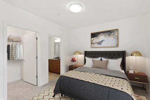 A bedroom with a large bed and a painting on the wall.
