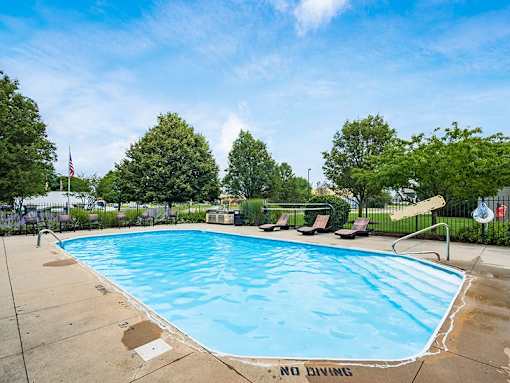 A pool with a no diving sign in the foreground.