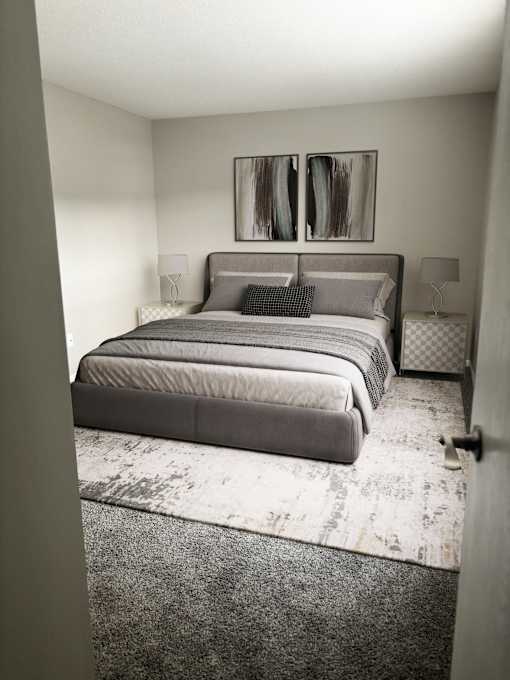 A bedroom with a large bed and a painting on the wall.