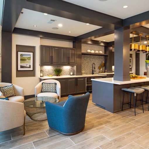 A modern kitchen with a bar area and seating.