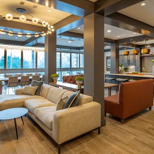 A modern living room with a large couch and a coffee table.