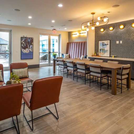 A dining room with a long table and chairs.