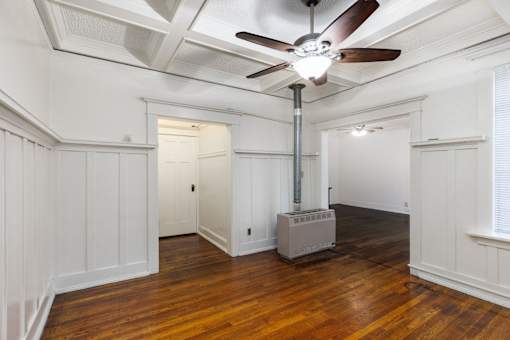 A room with a ceiling fan and a wood floor at Midtown Apartments, Portland, 97209