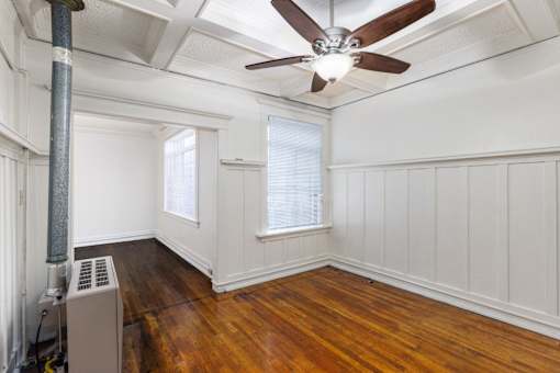 A room with a ceiling fan and a radiator on the floor at Midtown  Apartments, Portland, OR