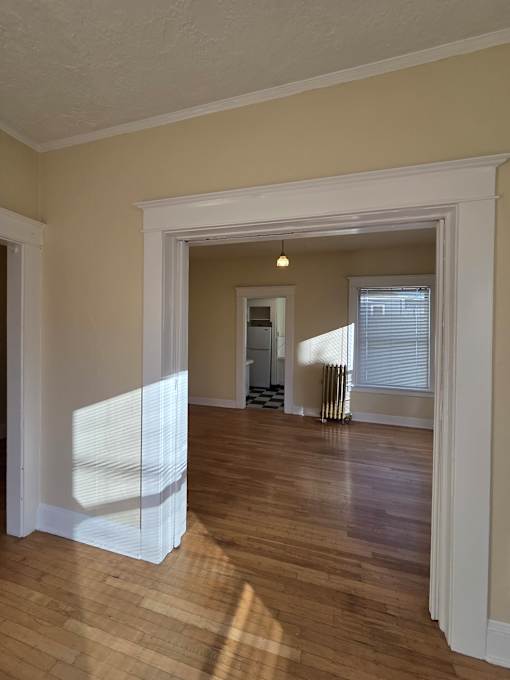 A white window in a room with wooden walls. at Casa Del Rey Apartments, Oregon, 97209