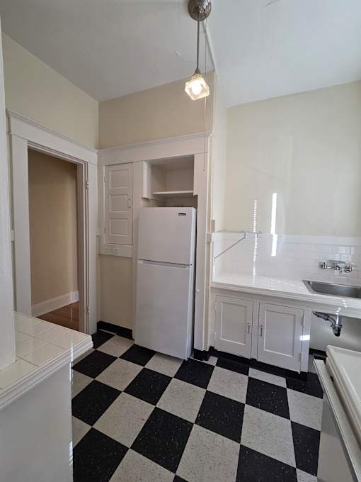 A black and white checkered floor in a kitchen. at Casa Del Rey Apartments, Portland