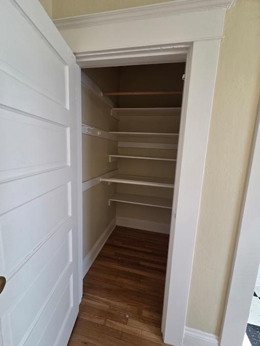 A white door is open to a room with wooden walls. at Casa Del Rey Apartments, Portland, Oregon
