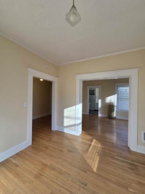 A white bathroom with a skylight and wooden walls. at Casa Del Rey Apartments, Portland