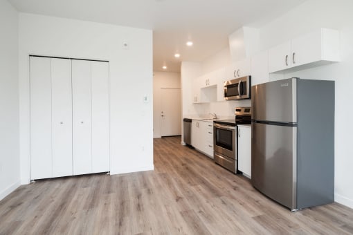 a kitchen with stainless steel appliances and white cabinets