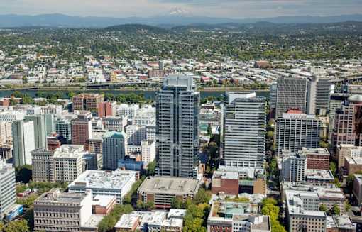 A cityscape with a mountain in the background.